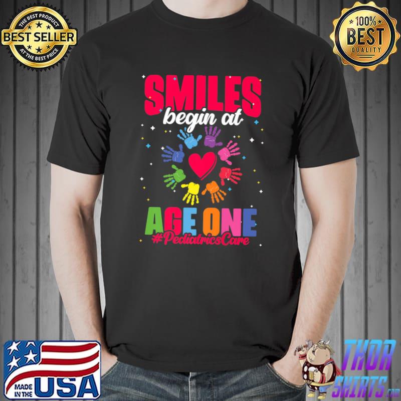 Smiles Begin At Age One Pediatrician Nurse Peds Pediatric Hands Colors T-Shirt